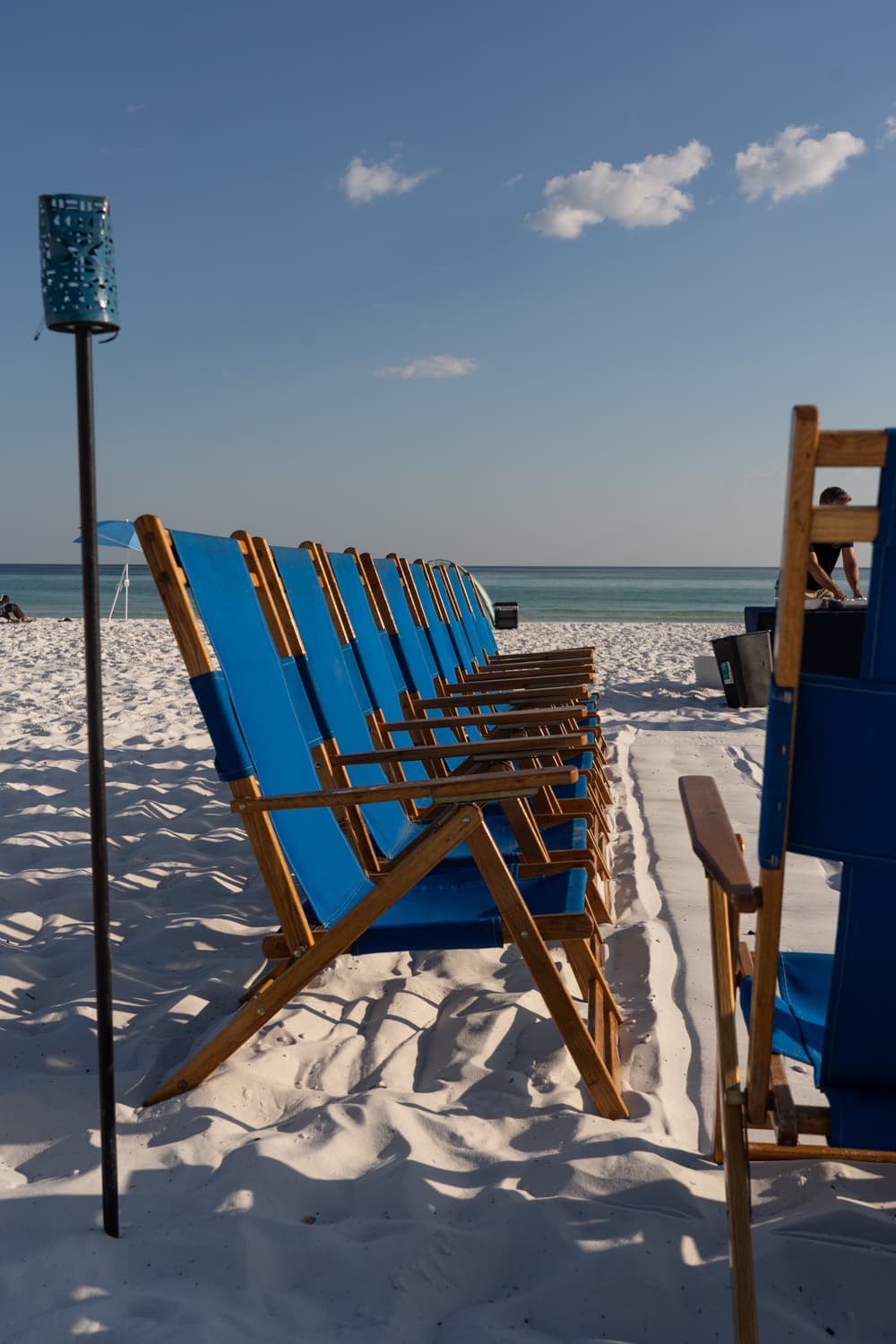 Beach chairs lined up along the shore on 30A